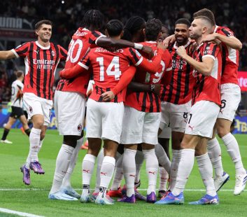 AC Milan celebrating a goal against Venezia at San Siro.