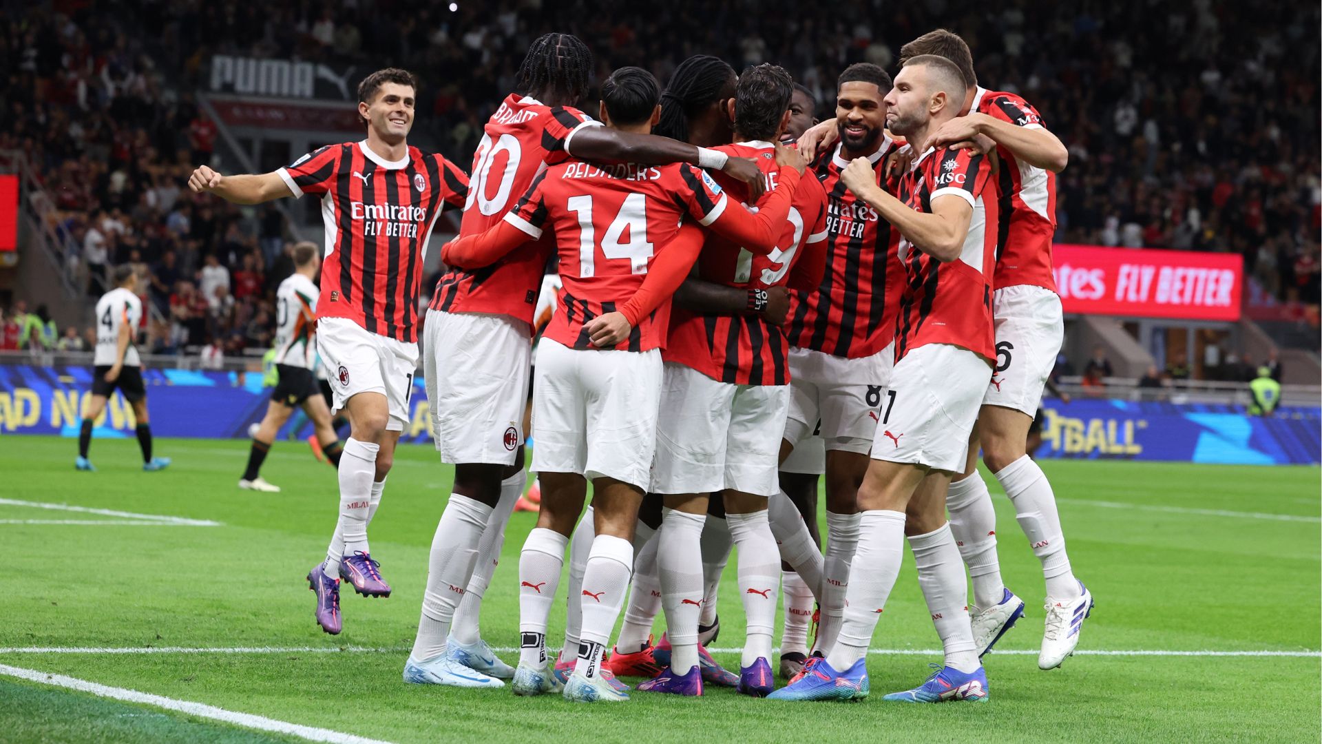 AC Milan celebrating a goal against Venezia at San Siro.